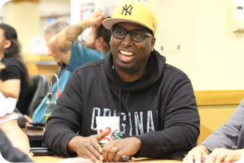 image of man at a poker table with a yellow new york yankees hat