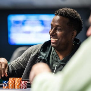 image of man smiling at a poker table